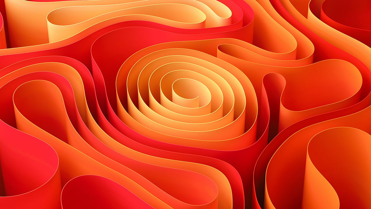 Abstract close-up of layered, curved paper art in shades of red, orange, and yellow forming swirling shapes.